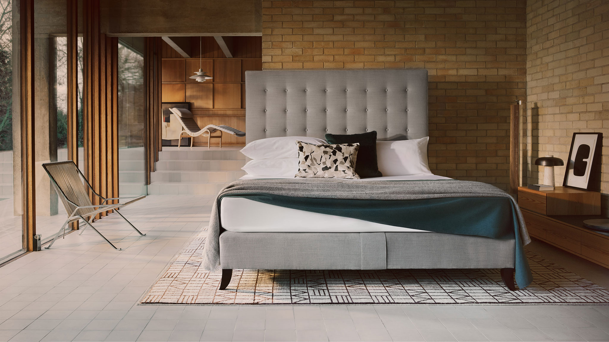 Savoir Holly bed features gentle buttoning and a piped edge